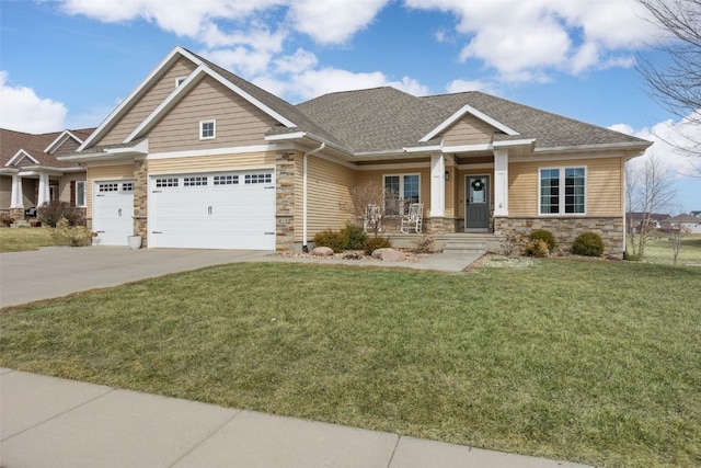 craftsman-style house featuring a front yard, concrete driveway, stone siding, and roof with shingles