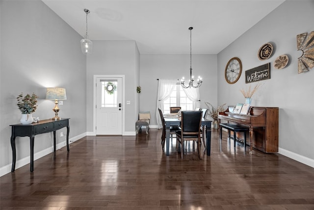 dining room featuring a notable chandelier, wood finished floors, baseboards, and high vaulted ceiling