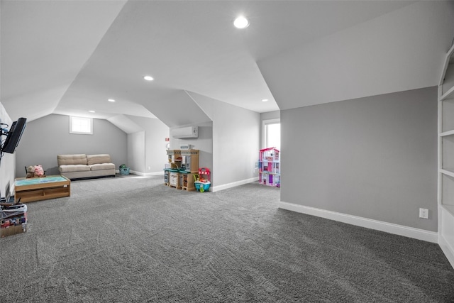 recreation room featuring a wall unit AC, plenty of natural light, baseboards, and lofted ceiling