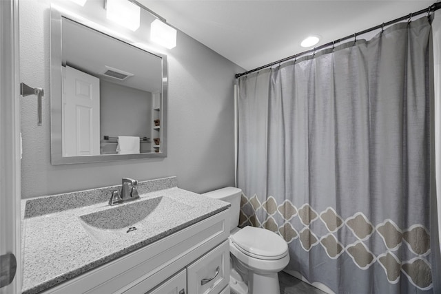 bathroom with visible vents, toilet, vanity, and a shower with shower curtain