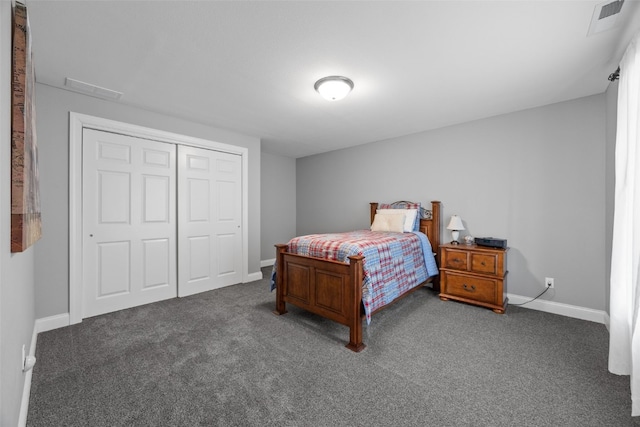 carpeted bedroom with visible vents, baseboards, and a closet