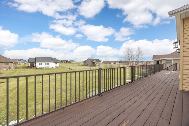 wooden terrace with a residential view and a lawn