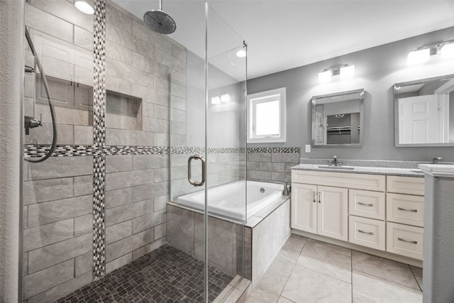 bathroom with vanity, a bath, and a shower stall