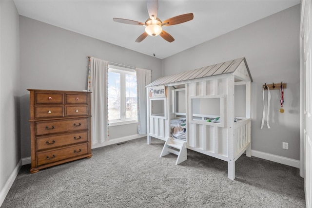 carpeted bedroom featuring visible vents, baseboards, and ceiling fan