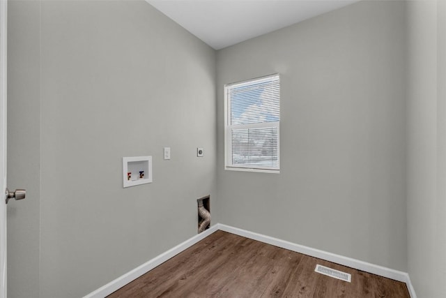 laundry room featuring wood finished floors, visible vents, laundry area, electric dryer hookup, and washer hookup