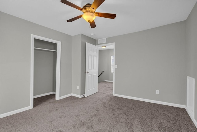 unfurnished bedroom with visible vents, baseboards, carpet floors, and ceiling fan