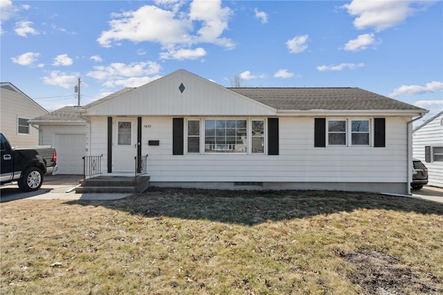 ranch-style house with an attached garage, concrete driveway, a front yard, and roof with shingles