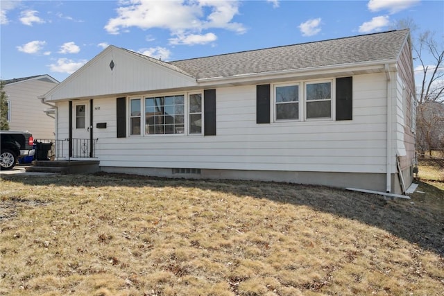 ranch-style home with roof with shingles