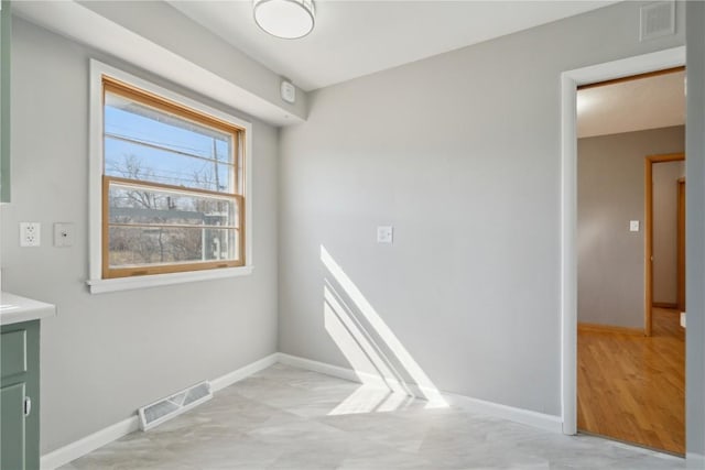 empty room featuring visible vents and baseboards