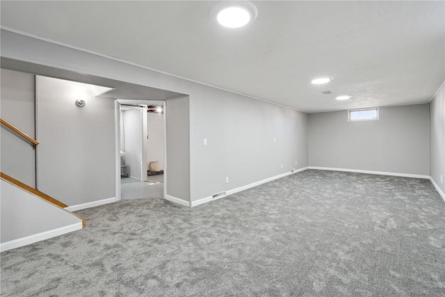 basement with baseboards, stairs, and carpet