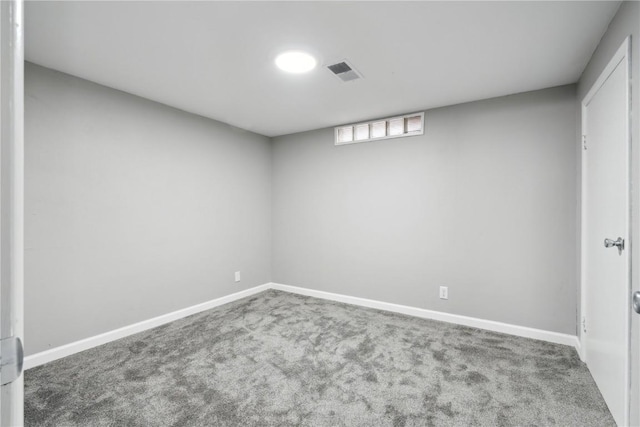 below grade area with carpet, visible vents, and baseboards