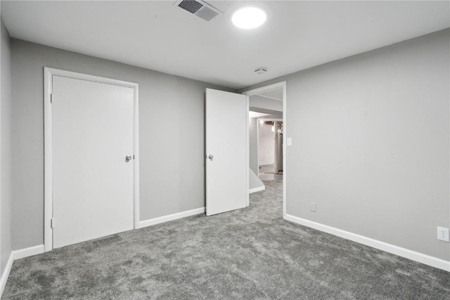 unfurnished bedroom featuring carpet flooring, baseboards, and visible vents