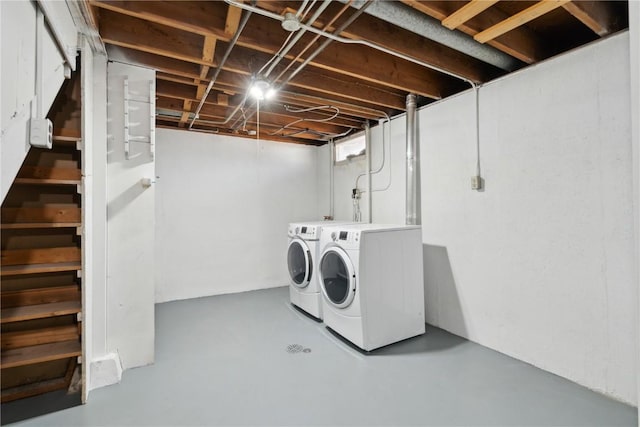 unfinished basement with washing machine and clothes dryer and stairway