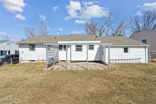 back of house featuring a patio area, a shingled roof, a yard, and fence