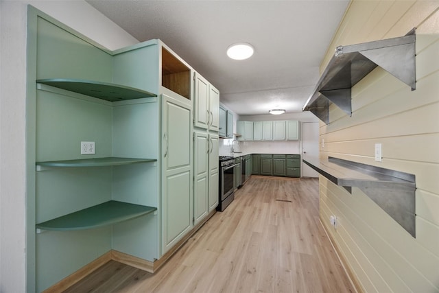 kitchen with open shelves, light wood-style flooring, and stainless steel gas range oven