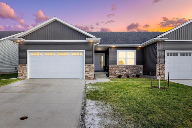 craftsman inspired home featuring a front yard, driveway, roof with shingles, an attached garage, and stone siding