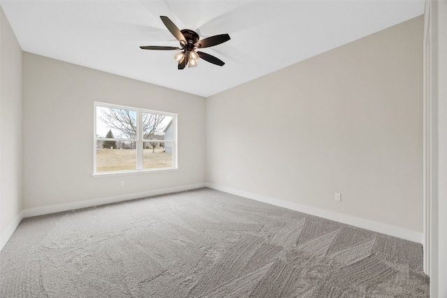 carpeted empty room with ceiling fan and baseboards