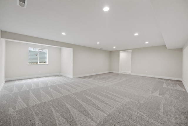 below grade area with recessed lighting, visible vents, carpet floors, and baseboards