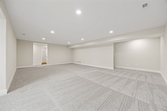 interior space featuring light colored carpet, recessed lighting, visible vents, and baseboards