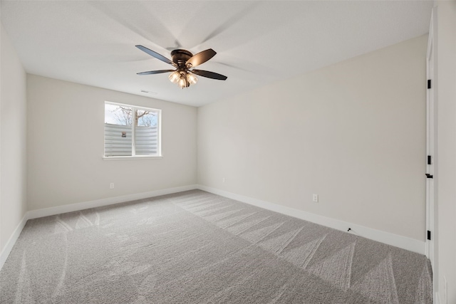 spare room with visible vents, baseboards, a ceiling fan, and carpet flooring