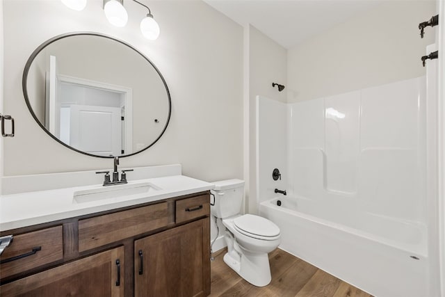 bathroom featuring shower / bath combination, toilet, wood finished floors, and vanity