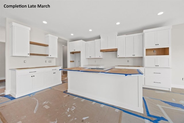 kitchen featuring white cabinetry, open shelves, recessed lighting, and a center island