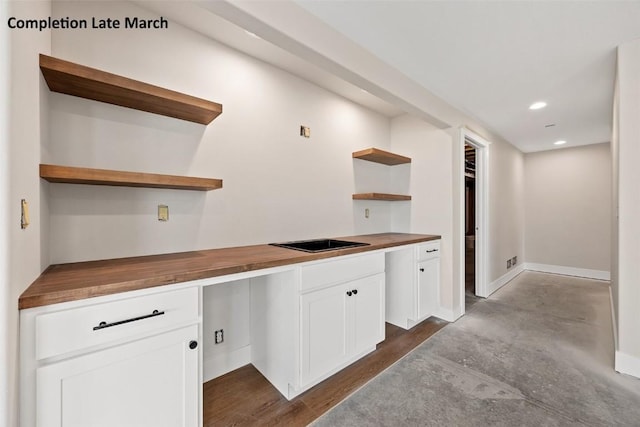 kitchen featuring recessed lighting, white cabinets, wooden counters, and open shelves