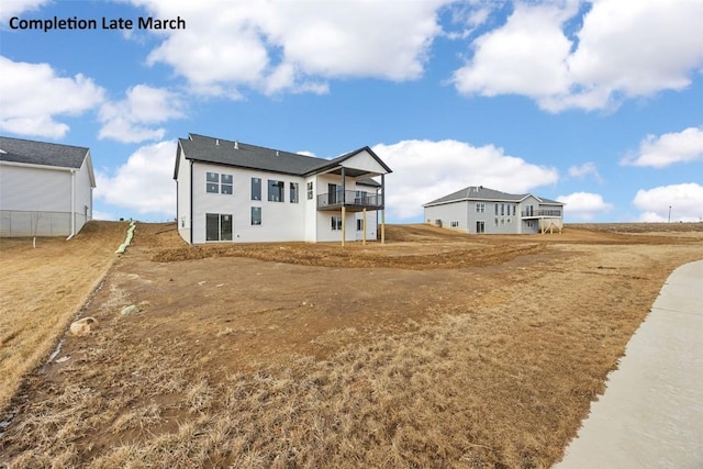 rear view of property featuring a balcony