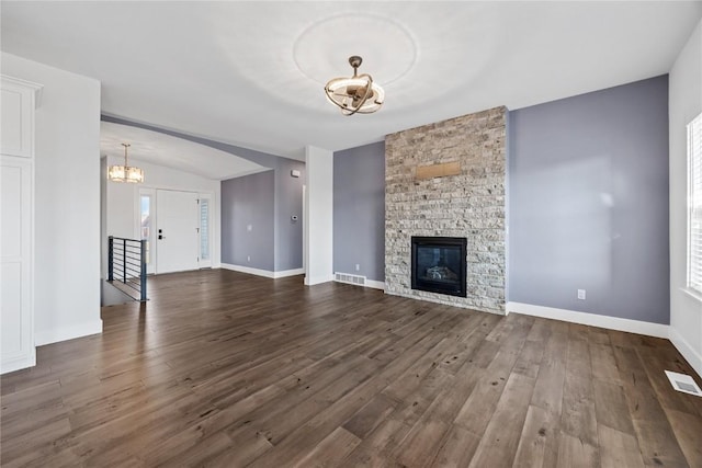 unfurnished living room with visible vents, a fireplace, baseboards, and dark wood-style flooring