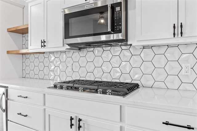 kitchen featuring white cabinetry, open shelves, light countertops, and appliances with stainless steel finishes