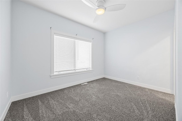 spare room featuring baseboards, carpet floors, visible vents, and ceiling fan