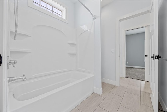 full bathroom featuring  shower combination and baseboards