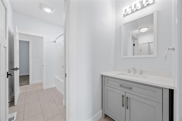 bathroom with vanity, bathing tub / shower combination, and baseboards