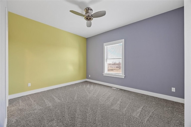 empty room with carpet, baseboards, and ceiling fan