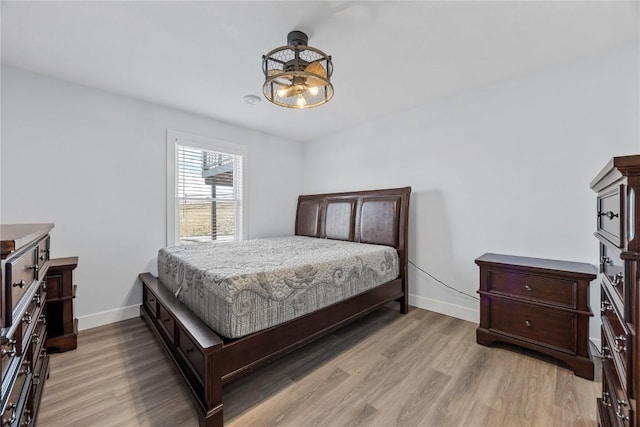 bedroom with baseboards and light wood-style flooring