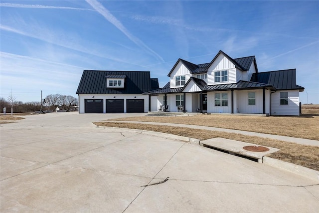 modern farmhouse with board and batten siding, metal roof, and a standing seam roof