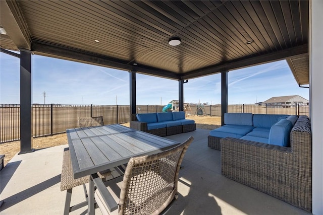 view of patio featuring an outdoor living space, outdoor dining area, and a fenced backyard