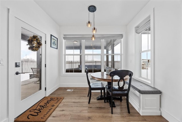 dining area featuring baseboards and wood finished floors