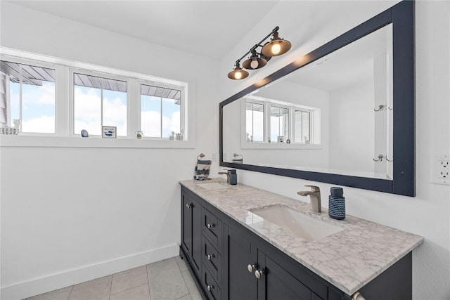 bathroom with a wealth of natural light, tile patterned flooring, and a sink