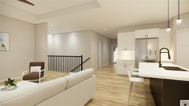 living room featuring recessed lighting, baseboards, light wood-style floors, and ceiling fan