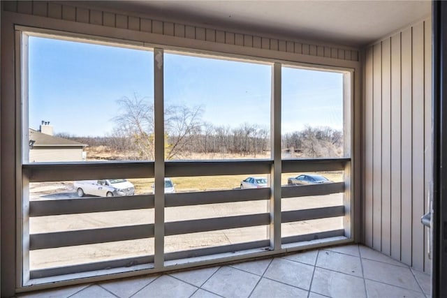 doorway to outside with tile patterned flooring