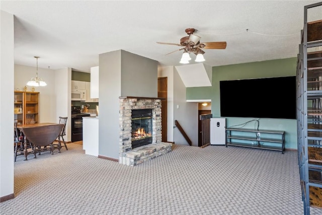 living room with carpet flooring, a brick fireplace, baseboards, and a ceiling fan