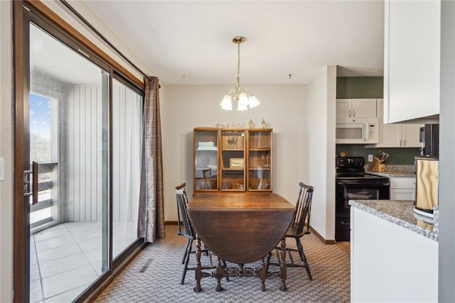 dining room with an inviting chandelier, light tile patterned flooring, baseboards, and visible vents