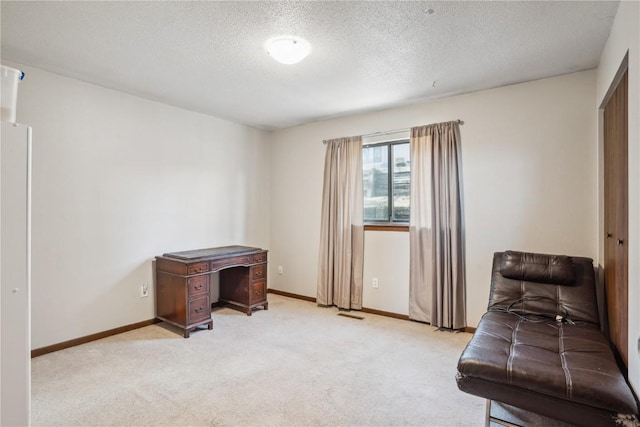 living area featuring a textured ceiling, baseboards, and light carpet