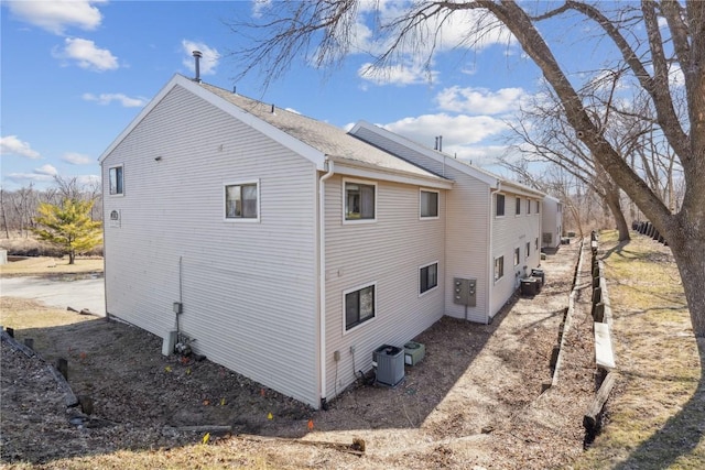 view of side of home featuring cooling unit