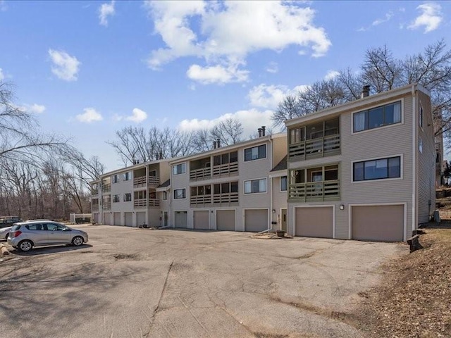 view of property with an attached garage and driveway