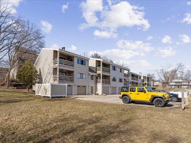 view of property featuring driveway and a garage