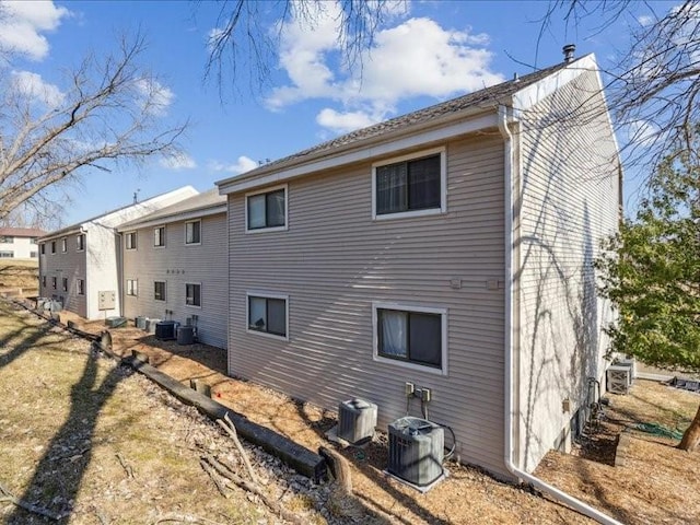 rear view of property with central AC unit