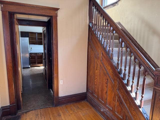 stairs featuring baseboards and hardwood / wood-style flooring