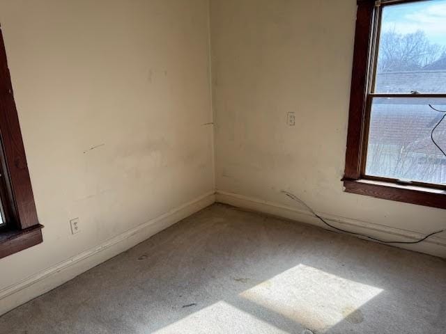 unfurnished room featuring baseboards